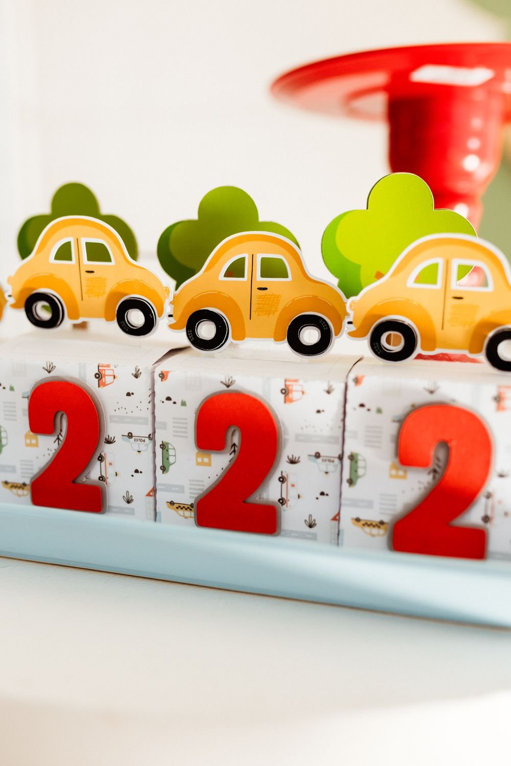 Colorful miniature cars displayed beside playful numbered blocks